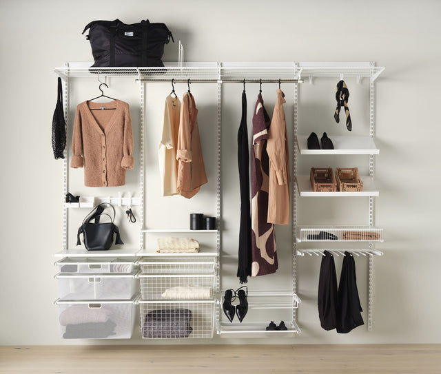 Elfa white wire shelving system installed in a bedroom wardrobe