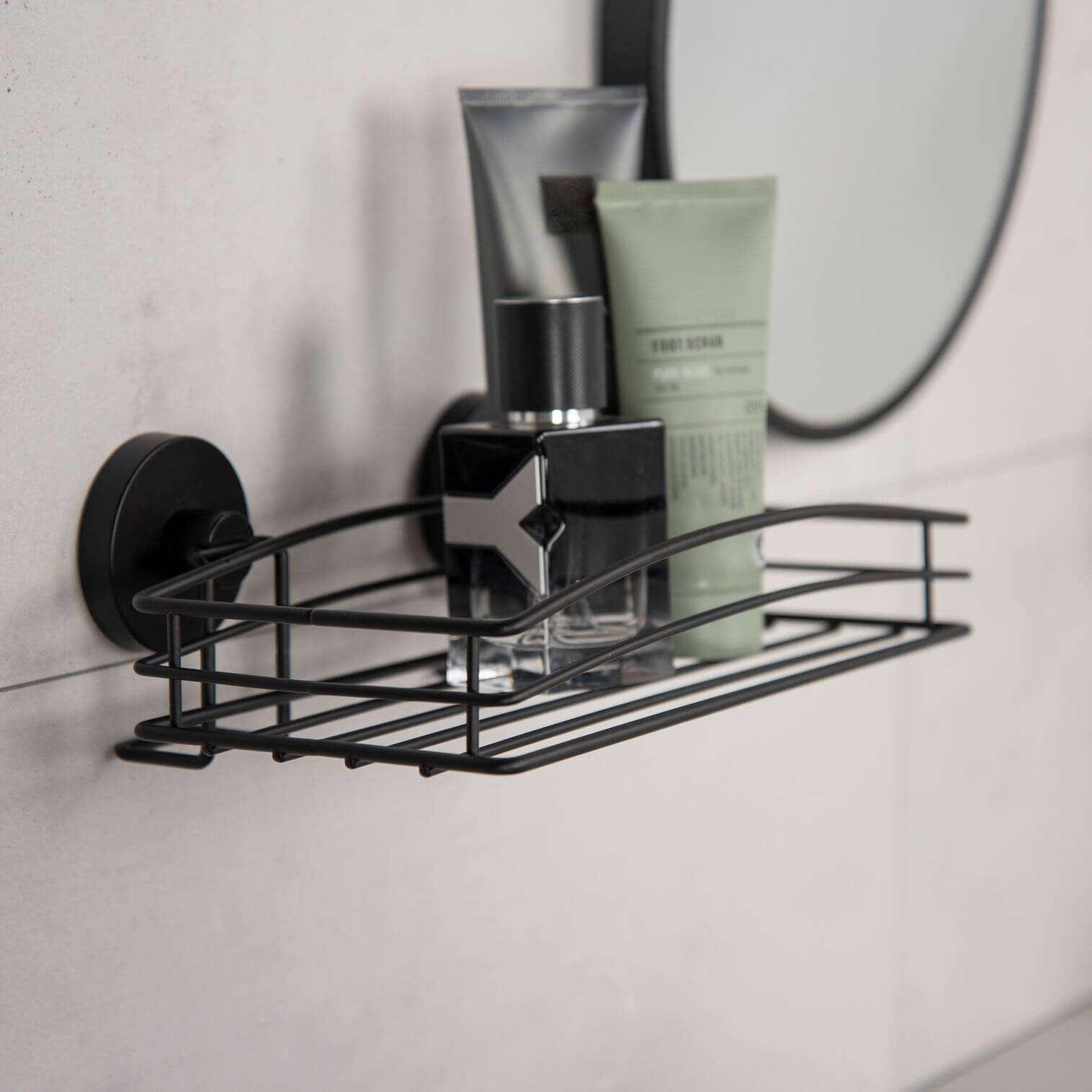 Matte black suction basket with skincare products stored inside